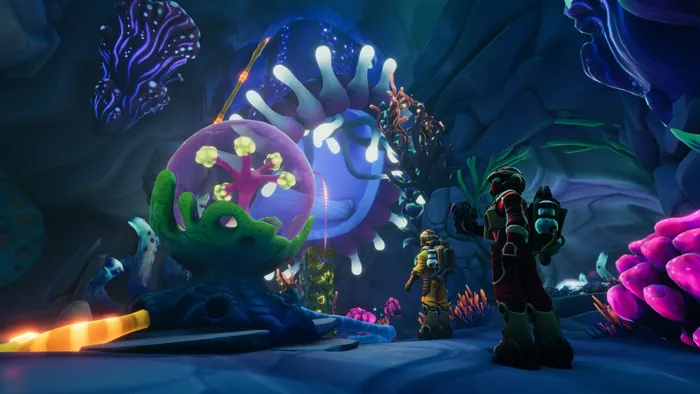 Two Explorers in diving suits facing a giant glowing anemone in an underwater cavern full of neon coral
